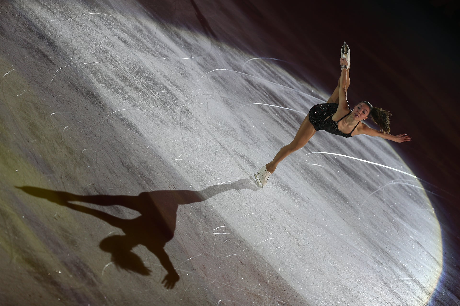 Speed skater dancing with her shadow